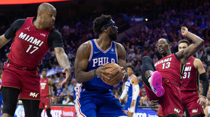 Philadelphia 76ers center Joel Embiid (center) controls the ball against Miami Heat forward P.J. Tucker (17) and center Bam Adebayo (13) during the third quarter in game six of the second round of the 2022 NBA playoffs.